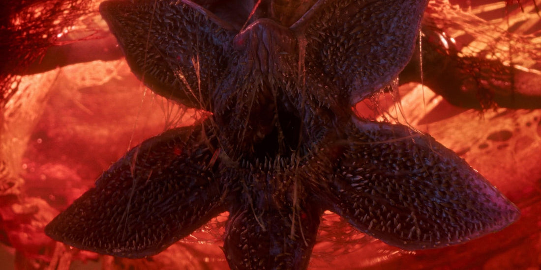 The Demogorgon, mouth open like a flower, under red light