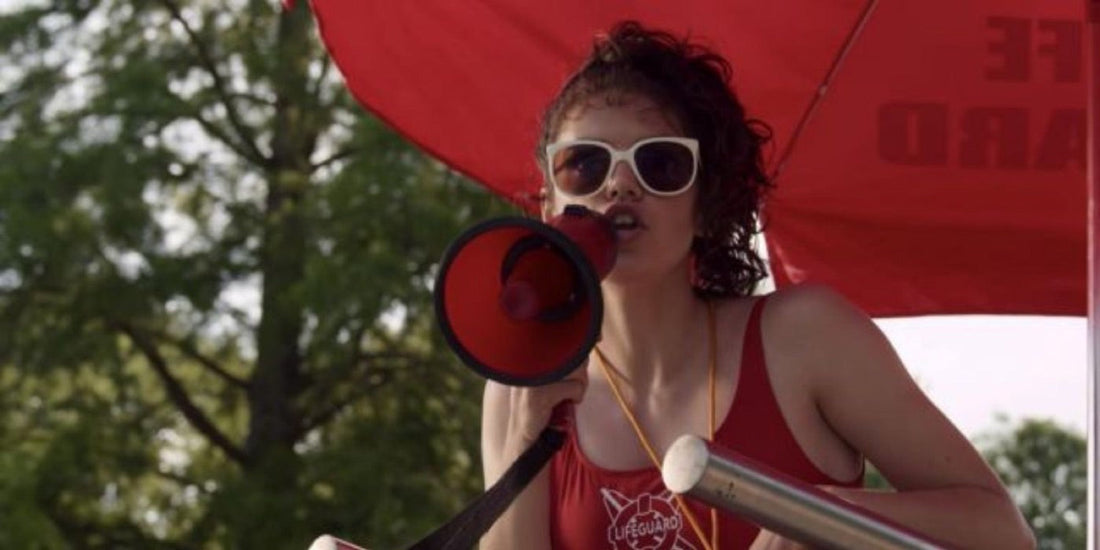 Heather Holloway, lifeguard, speaks into a megaphone at the pool.