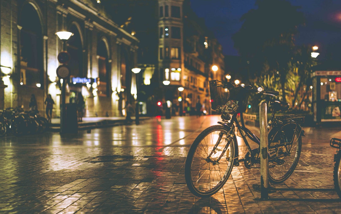 Night street, lamps and a bicycle, orange light on the asphalt