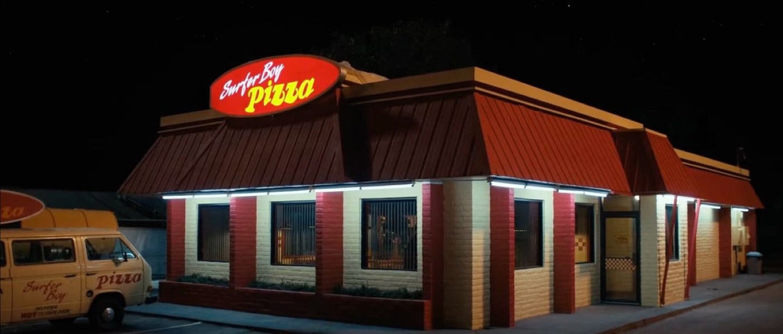 Restaurant at night, yellow van parked under the lit sign